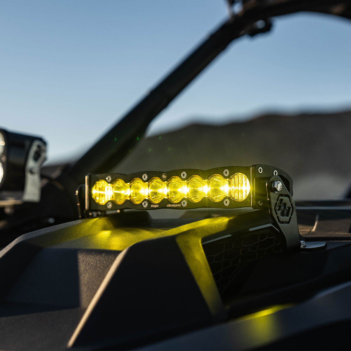 Yellow LED light bar on a vehicle with a mountainous landscape in the background