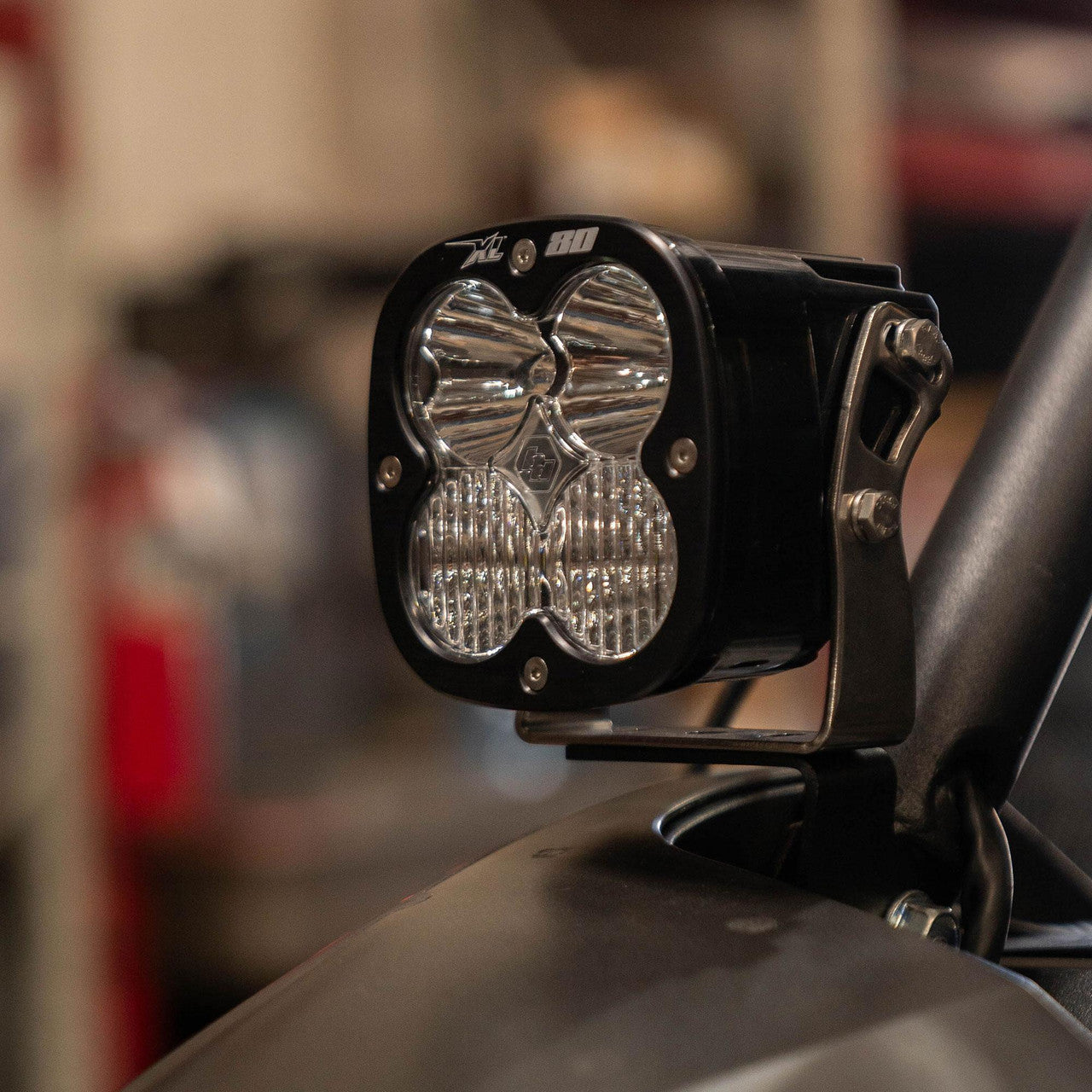 Off-road vehicle light mounted on a vehicle in a blurred indoor setting